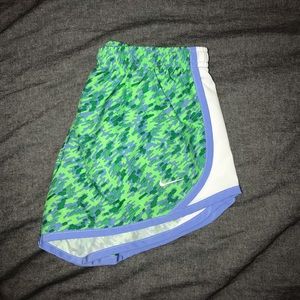 green patterned nike running shorts